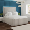 Neatly made bed with white bedding in a bedroom setting.