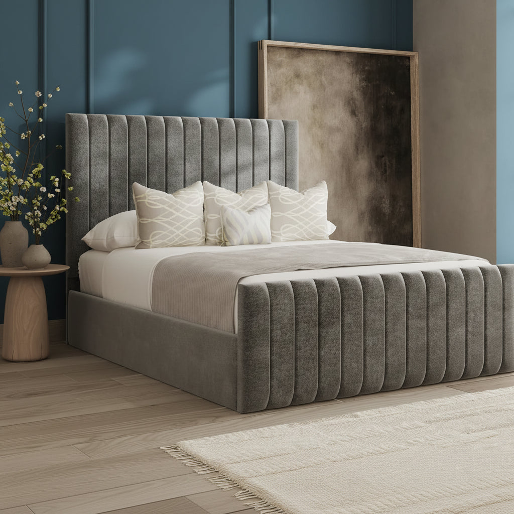 Gray upholstered bed with decorative pillows in a bedroom setting.