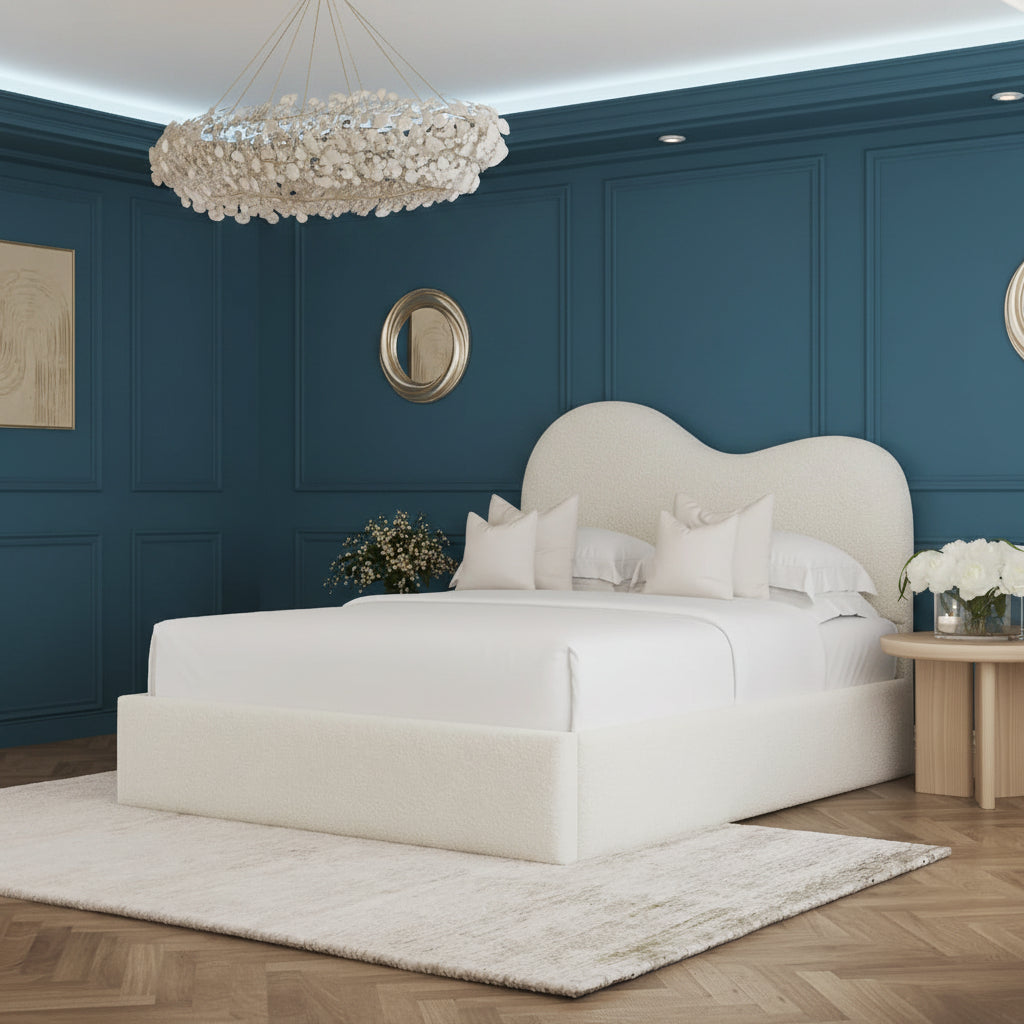 Luxurious bedroom with a large bed, decorative pillows, and a chandelier.