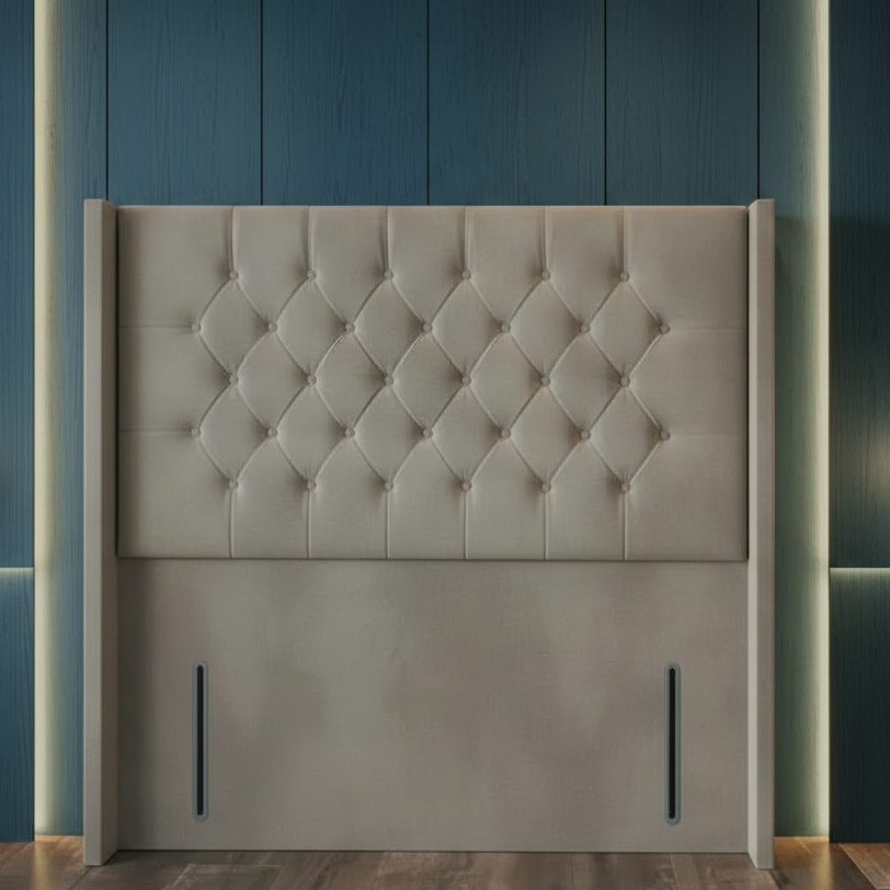 Gray tufted headboard against a blue paneled wall with two hanging lights.