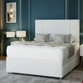 Gray upholstered bed in a bedroom with blue walls and decorative elements.