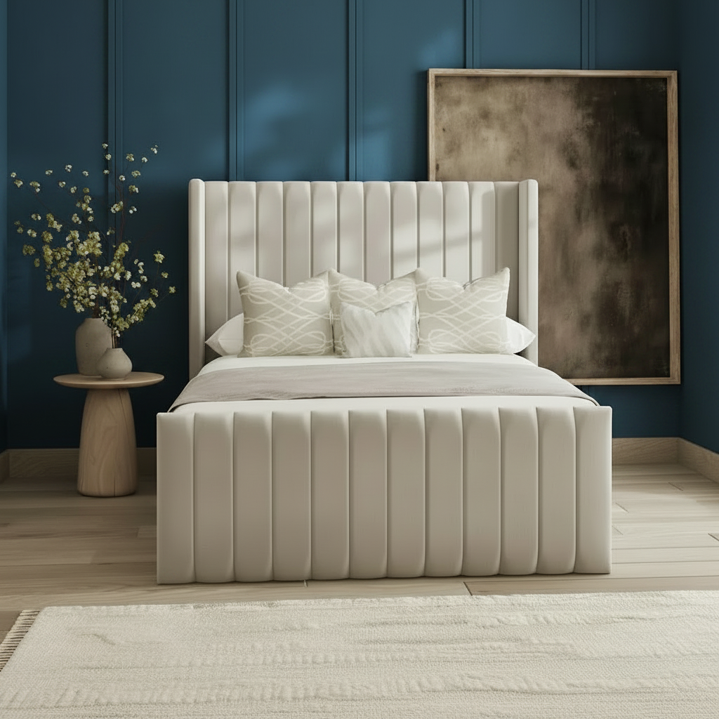 Beige upholstered bed in a bedroom setting with a side table and artwork.