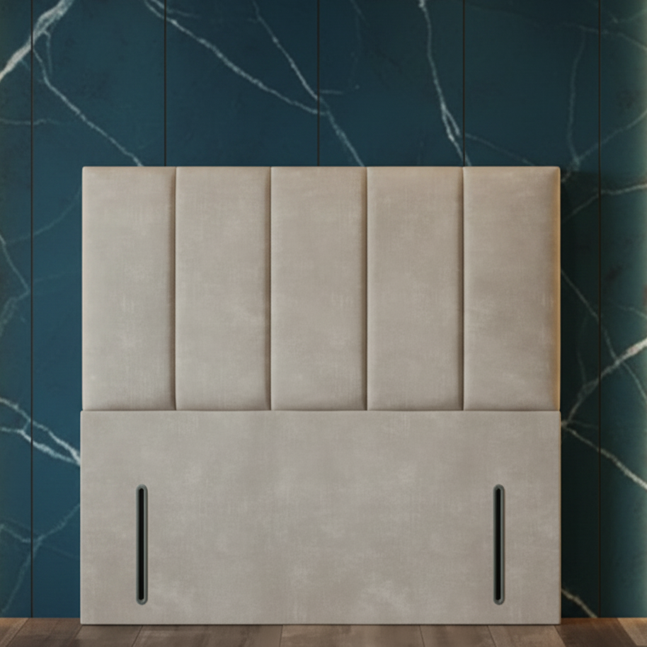 Modern bedroom with a large upholstered headboard against a marble wall.