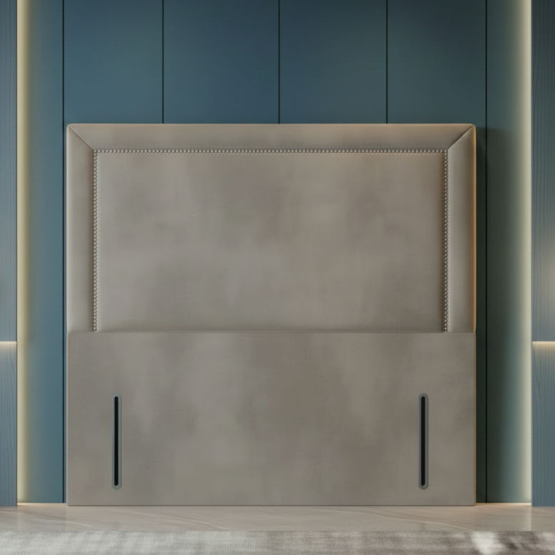 Gray upholstered headboard against a blue paneled wall with pendant lights.