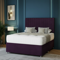 Modern bedroom with a large bed, decorative headboard, and stylish lighting fixtures.