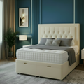 Modern bedroom with a gray upholstered bed, nightstands, and decorative elements.