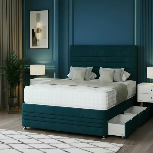 Beige upholstered bed with storage drawers in a bedroom setting with blue walls.