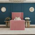 Pink upholstered bed in a stylish bedroom with decorative elements.