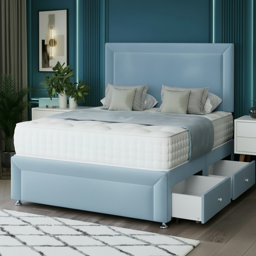Beige upholstered bed with storage drawers in a room with blue walls and a rug.