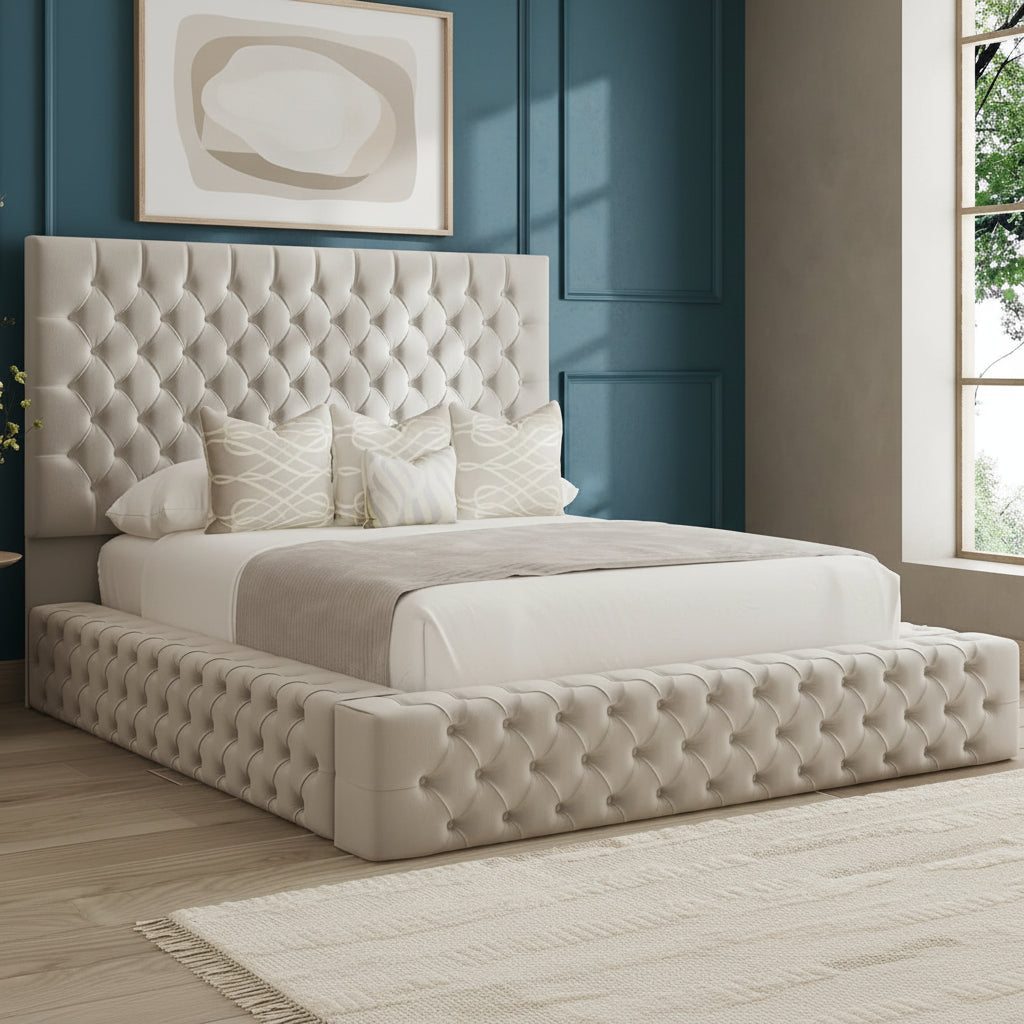 Beige tufted bed with pillows in a room with a large window.