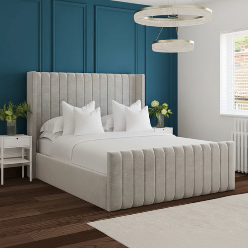 Modern bedroom with a gray upholstered bed and white bedding.